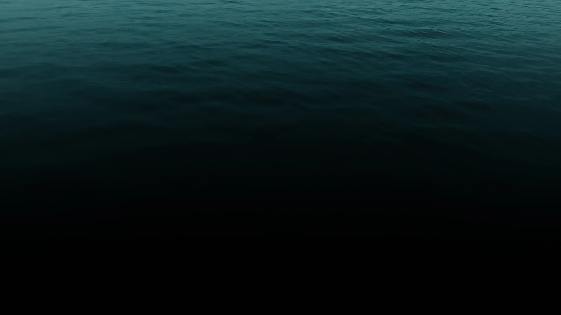 Calm open sea at dusk, deep teal water fading to black